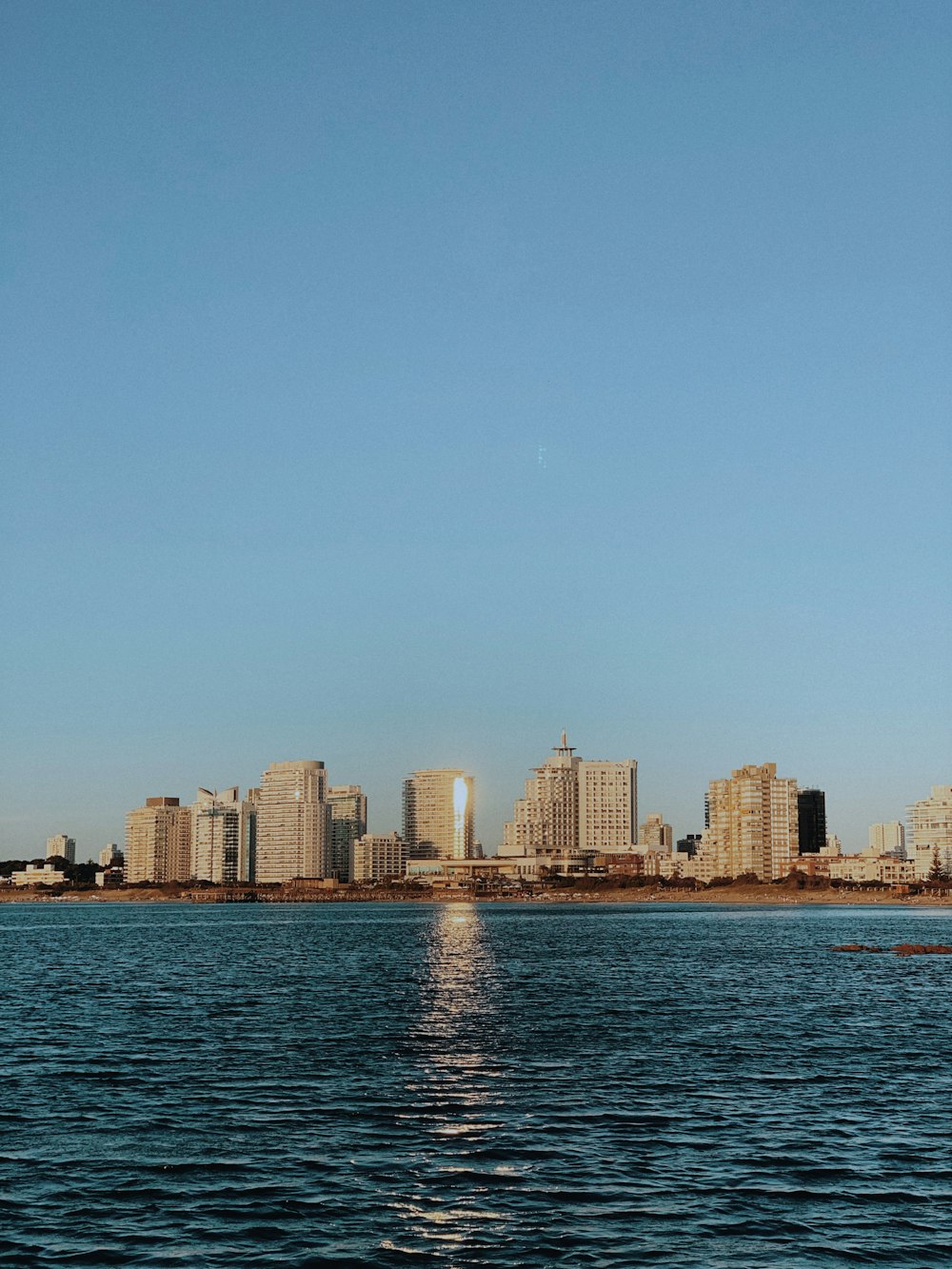 a large body of water with a city in the background