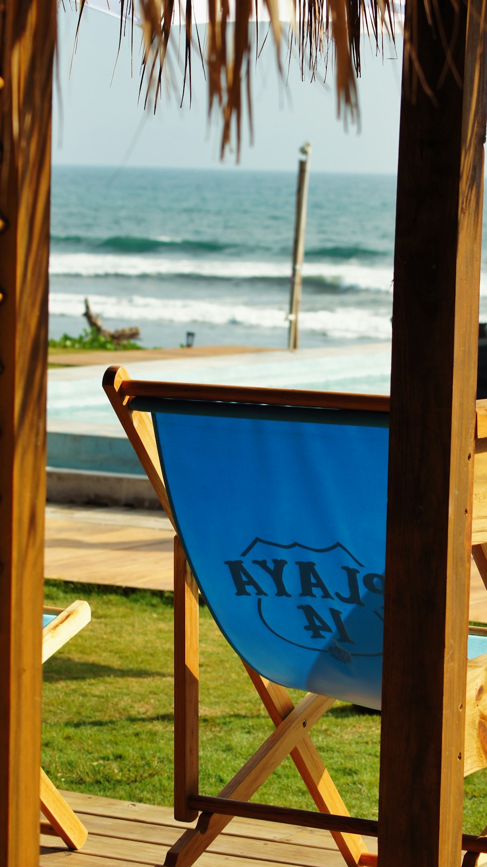 a blue beach chair sitting on top of a wooden deck