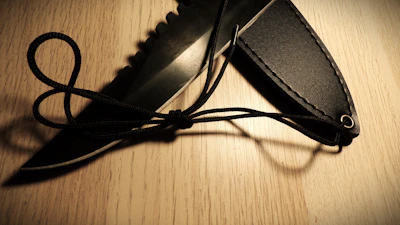 Sheath system featuring ballistic nylon belt mount with a survival knife securely fastened.