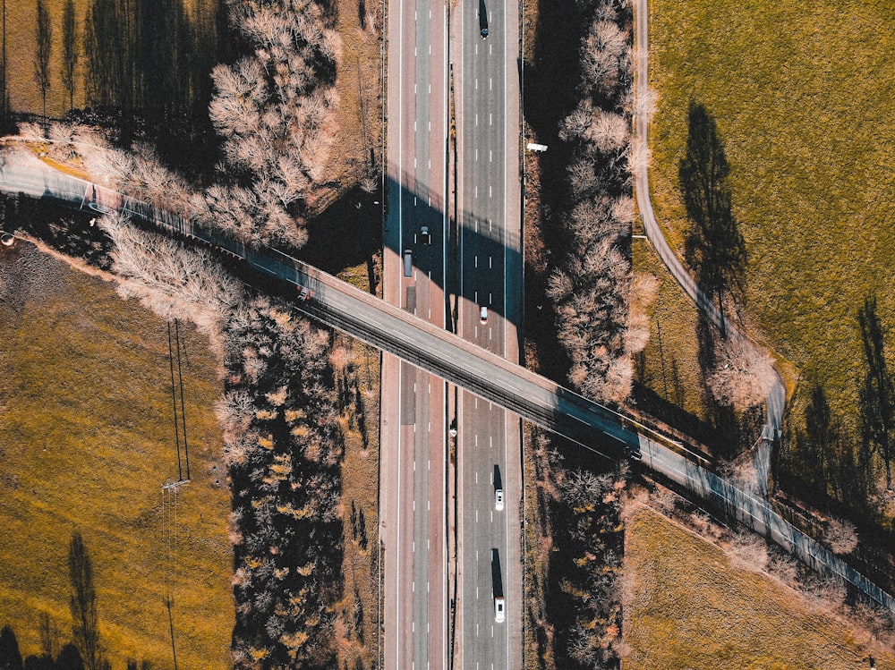 an aerial view of a highway with a few cars on it