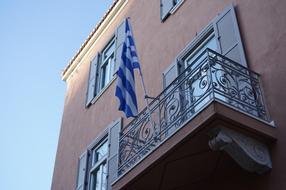a building with a balcony and a flag on it
