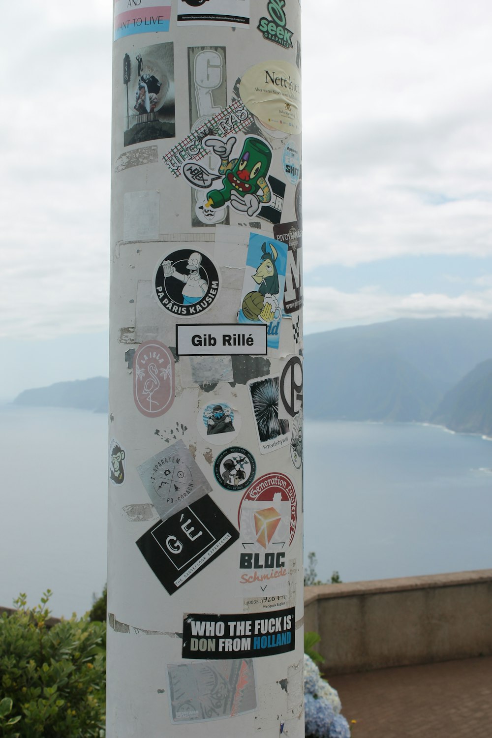 a pole with a bunch of stickers on it