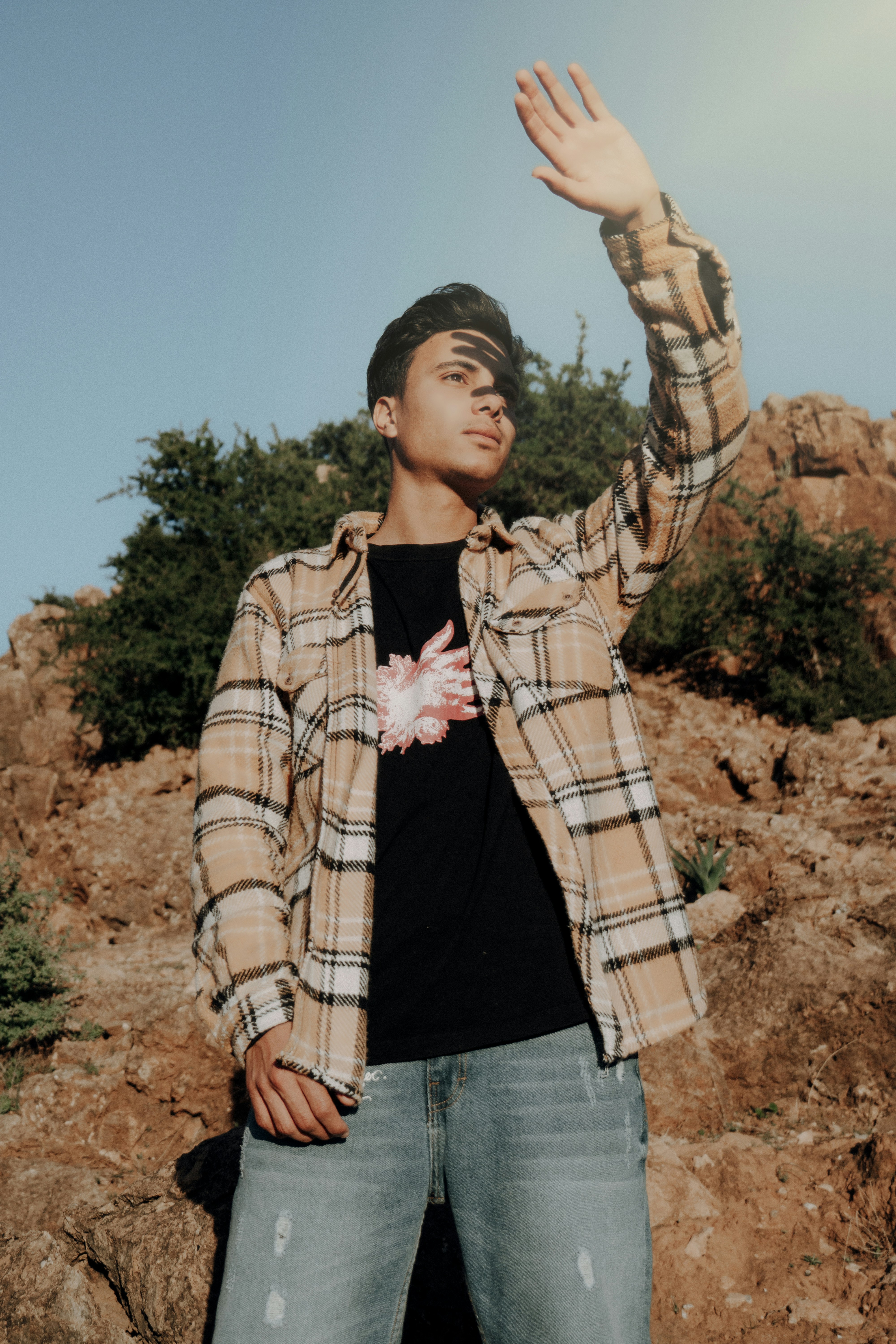 a man standing in front of a rocky mountain