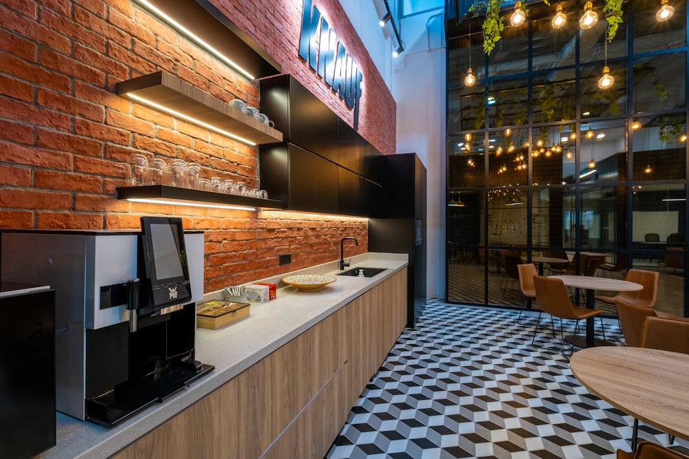 a coffee shop with a brick wall and a checkered floor