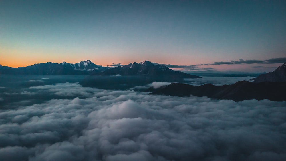 a view of a mountain range from above the clouds