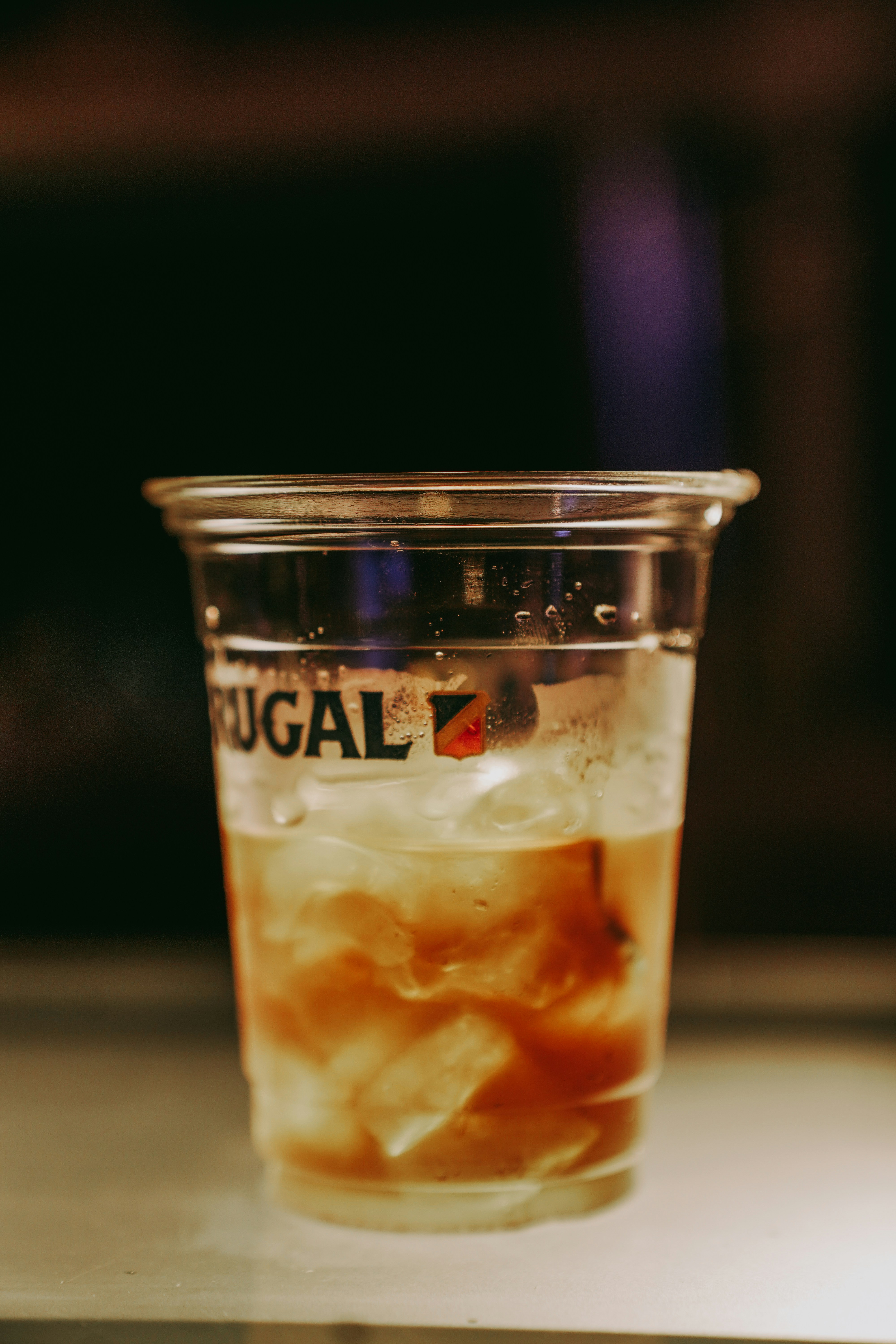 a glass of liquid sitting on top of a table