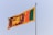 the flag of sri is flying high in the sky