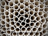 A close-up of various types of durable pipes stacked together.