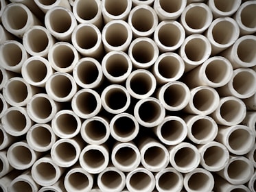 Close-up of high-quality UPVC pipes stacked in a factory warehouse.