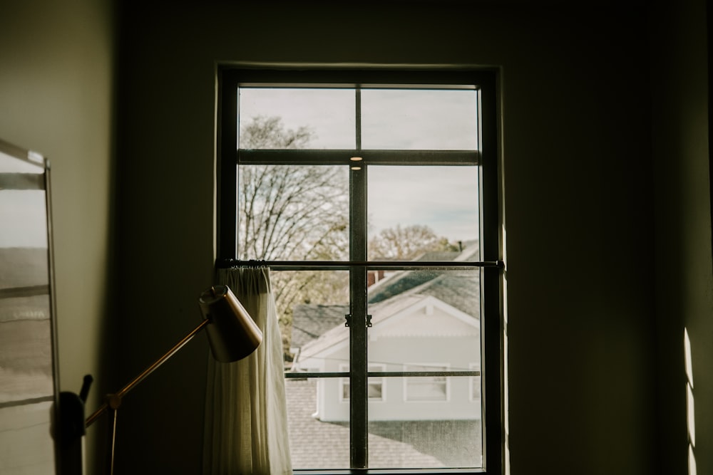 a room with a lamp and a window