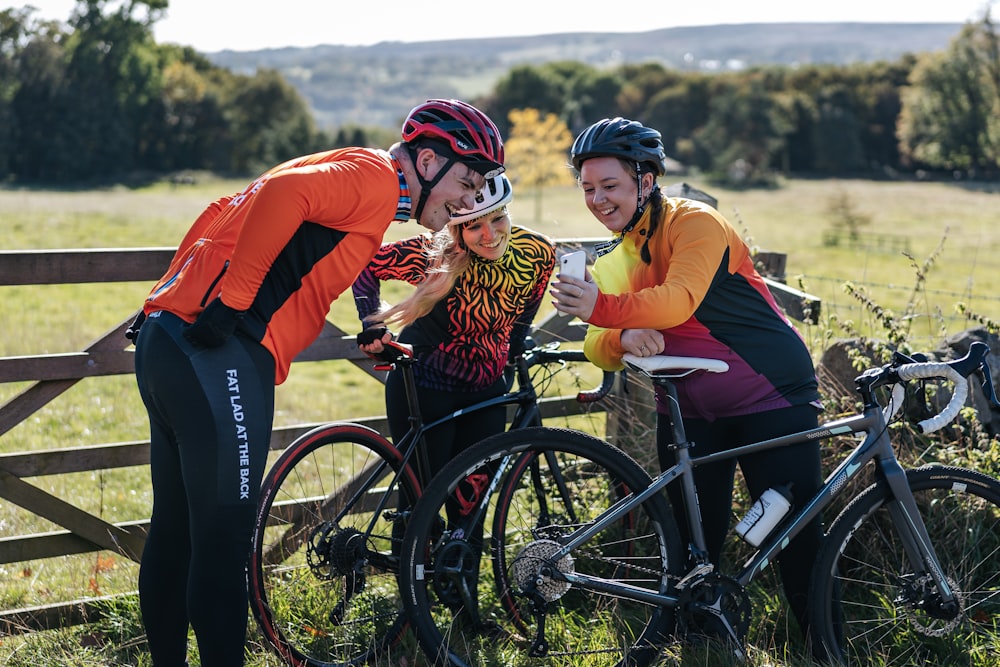 a group of people standing next to each other near bikes