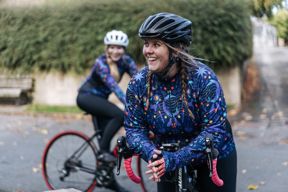 a couple of women riding bikes down a street