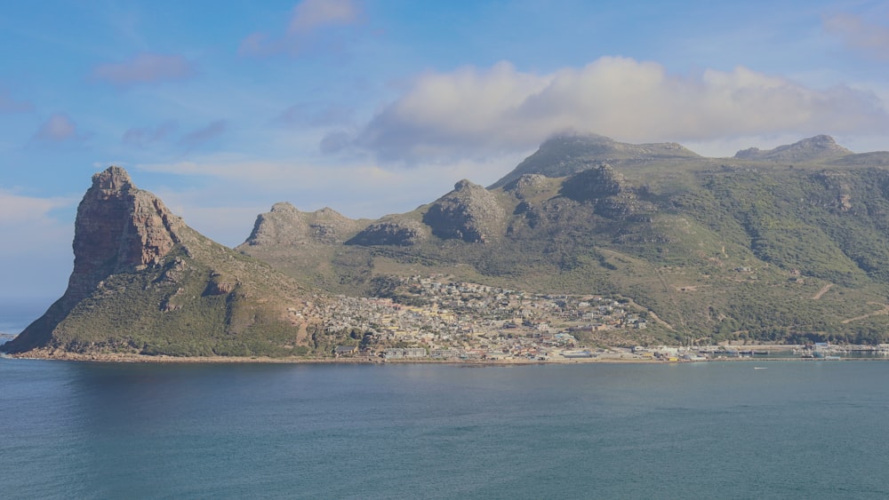 a large body of water with a mountain in the background