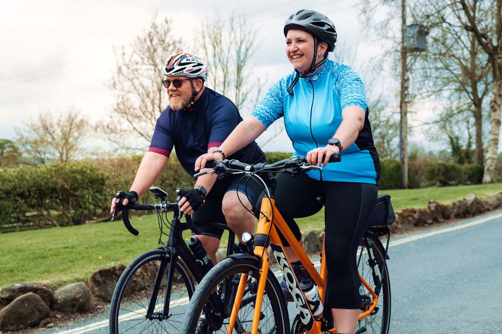 a man and a woman riding bikes on a road