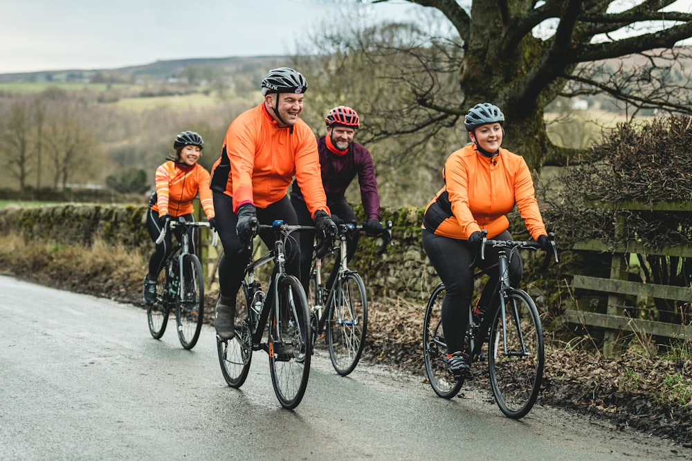 a group of people riding bikes down a road