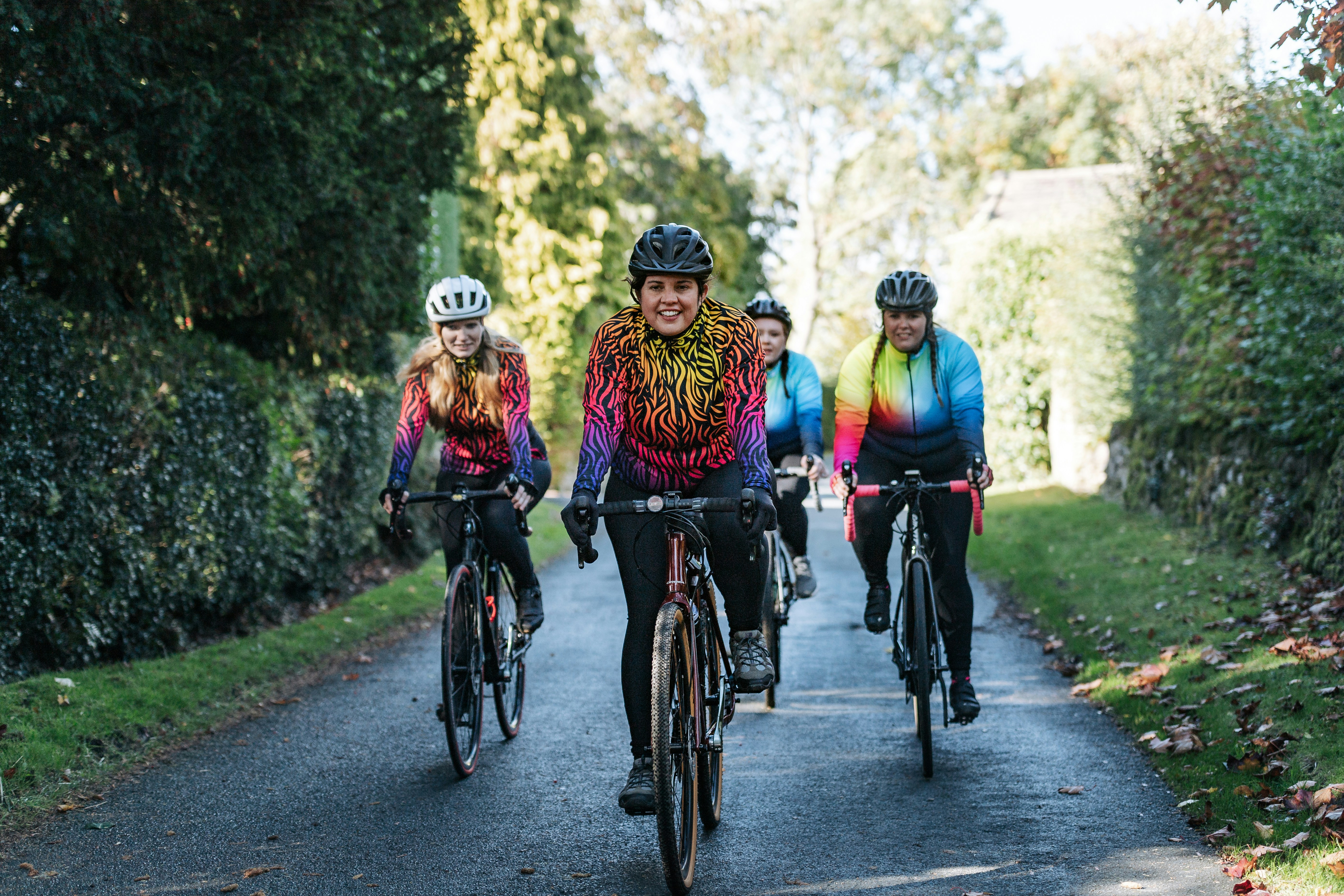 a group of people riding bikes down a road