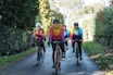 Group of friends riding traditional bicycles along the lush green trails near Costa da Caparica