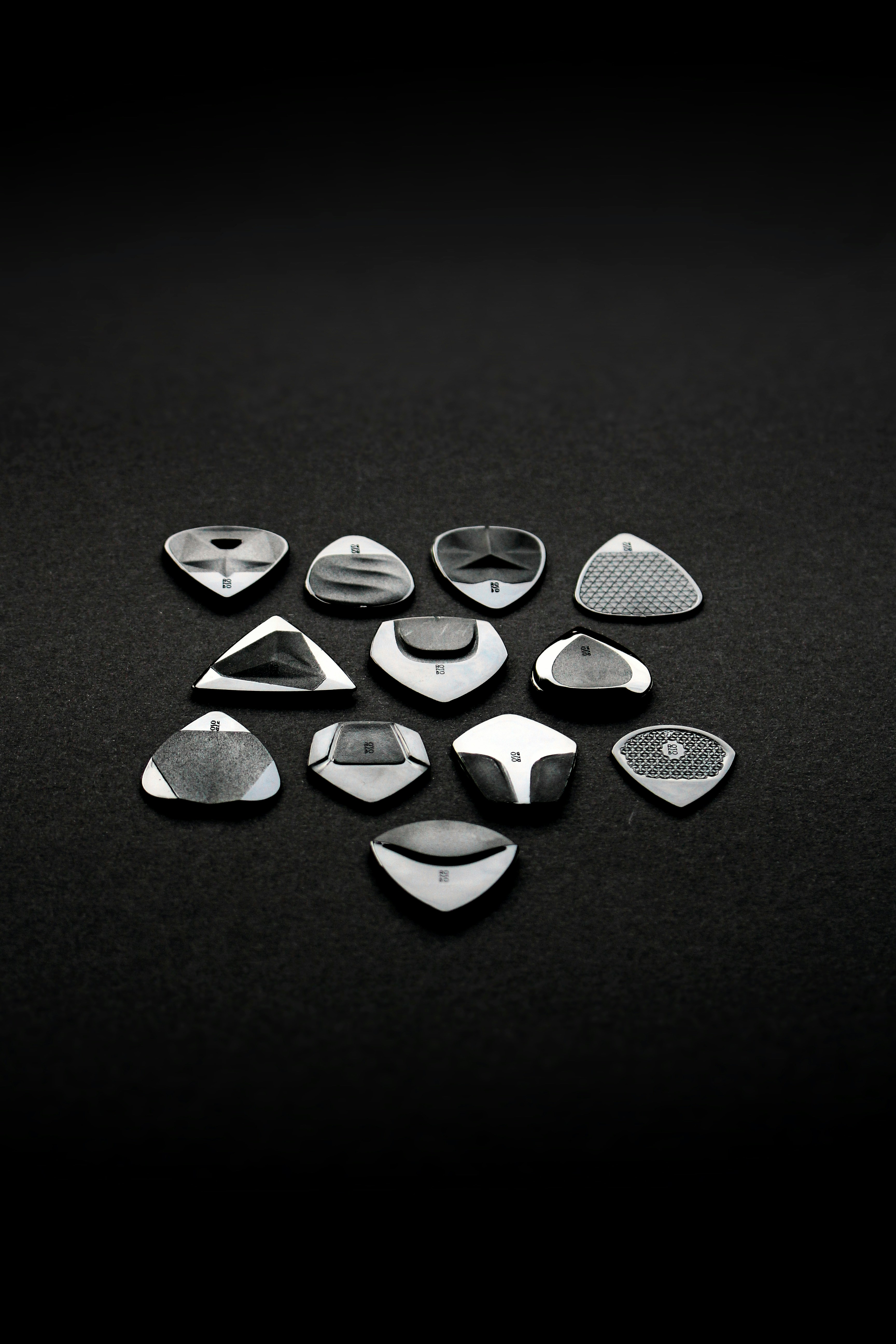 a collection of metal objects on a black surface