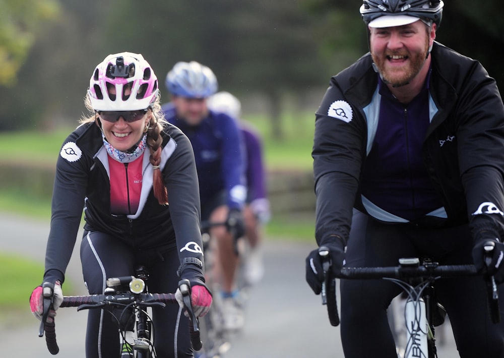 a group of people riding bikes down a road