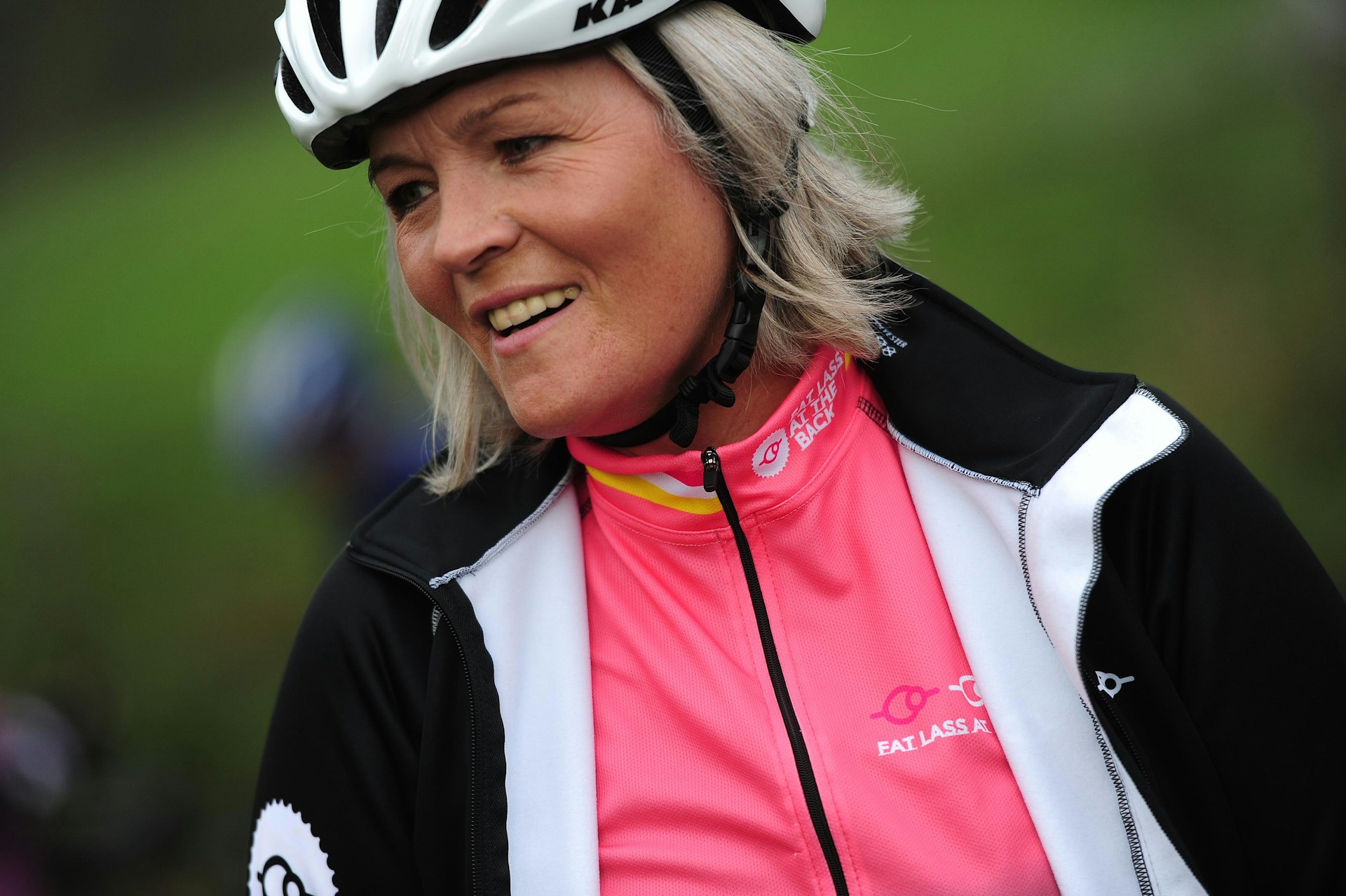 a woman wearing a helmet and smiling for the camera