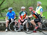 A team meeting outdoors with bikes in the background.