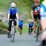 a group of people riding bikes down a road
