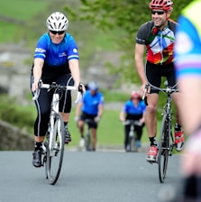 a group of people riding bikes down a road