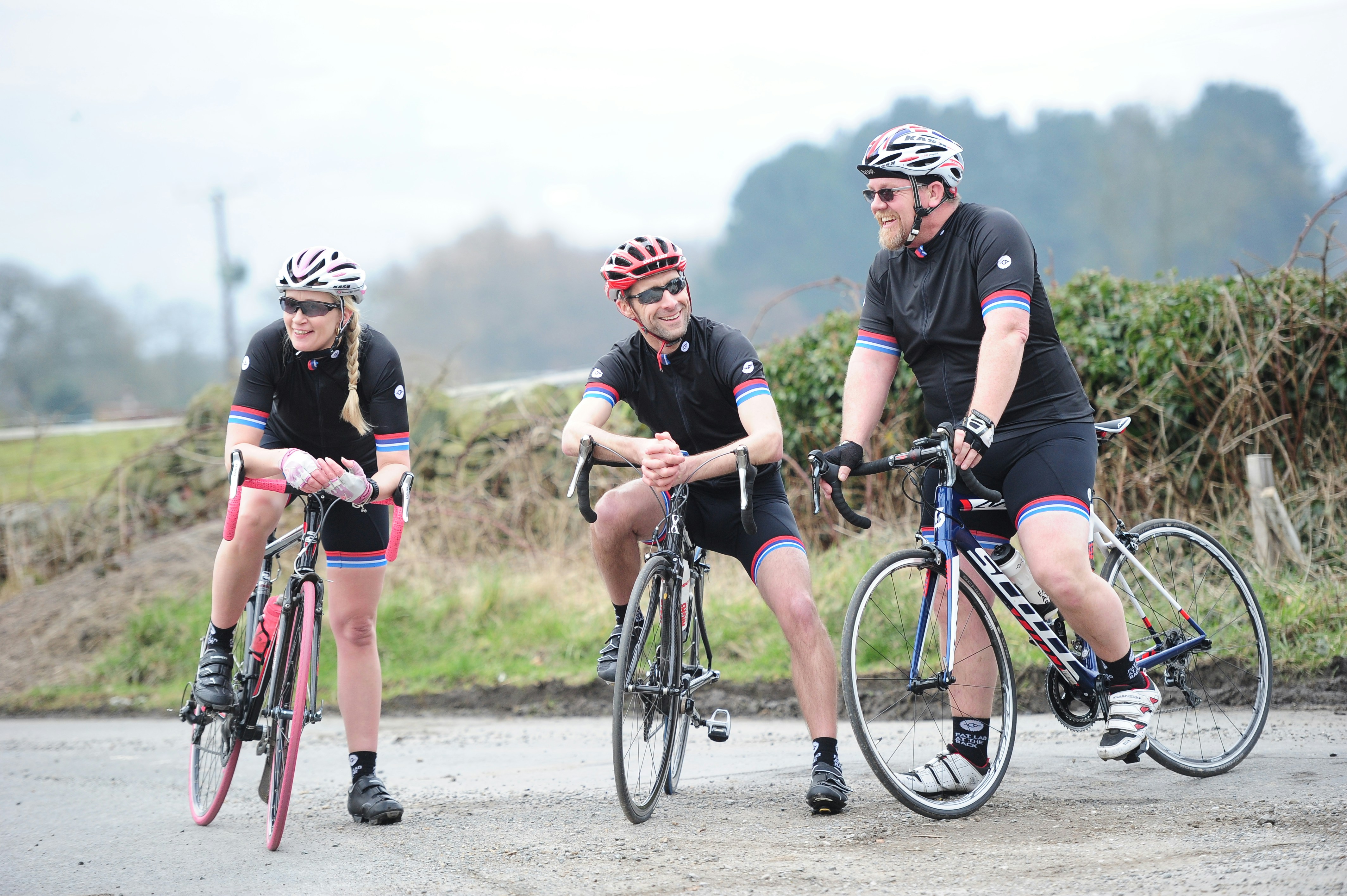 a group of people riding bikes down a road