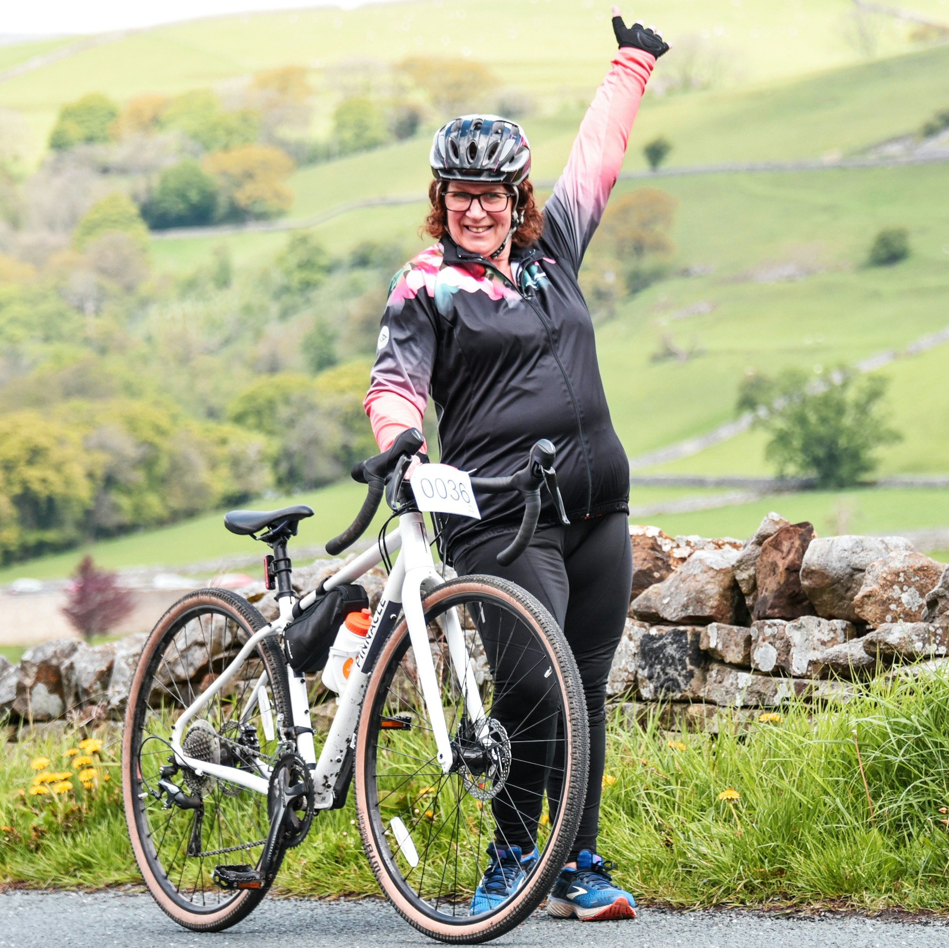 Santiago celebrating a recent competition finish line with a joyful smile and raised arms.