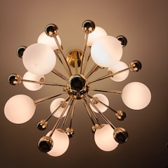 A sleek modern chandelier casting warm light over a stylish living room.