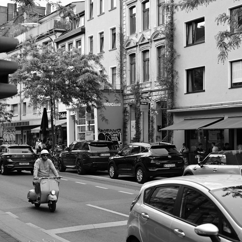 a person riding a scooter on a city street