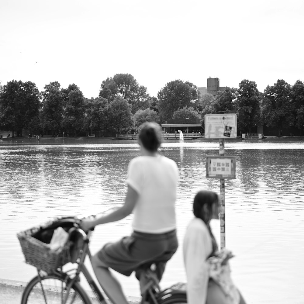 a man riding a bike next to a woman