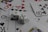 A collection of playing cards spread out, featuring various suits such as hearts, clubs, and spades. Two white dice with black dots are placed prominently on top of the cards.