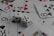 A collection of playing cards spread out, featuring various suits such as hearts, clubs, and spades. Two white dice with black dots are placed prominently on top of the cards.