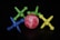 A collection of colorful plastic jacks and a marble-like ball spread out on a dark surface. The jacks come in various colors including green, blue, and yellow, while the ball has a pink and white marbled pattern.