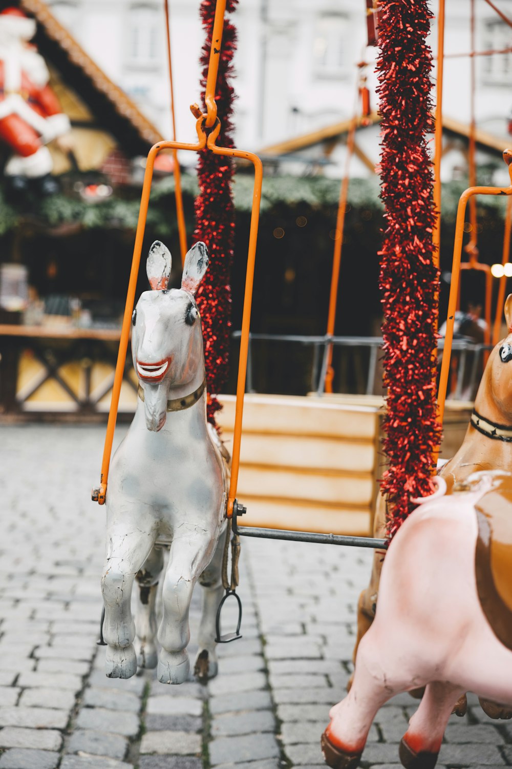 a couple of toy horses on a merry go round