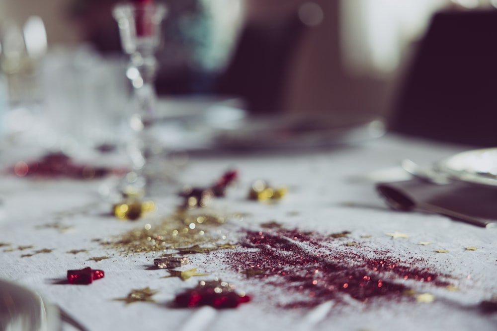 a table topped with a white table cloth covered in confetti