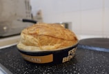 Happy customer enjoying a warm slice of Eli’s meat pie at home.