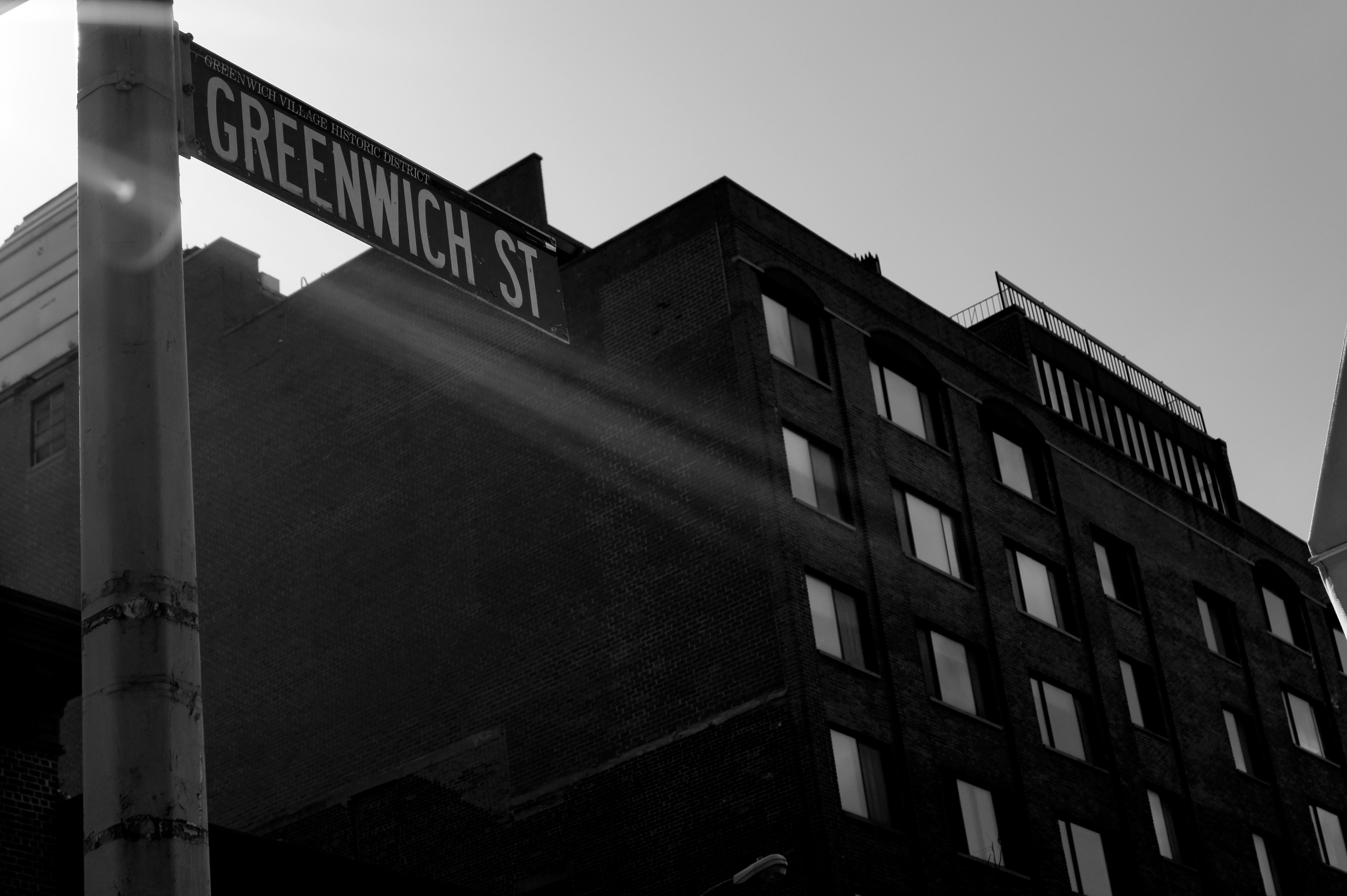 a black and white photo of a street sign