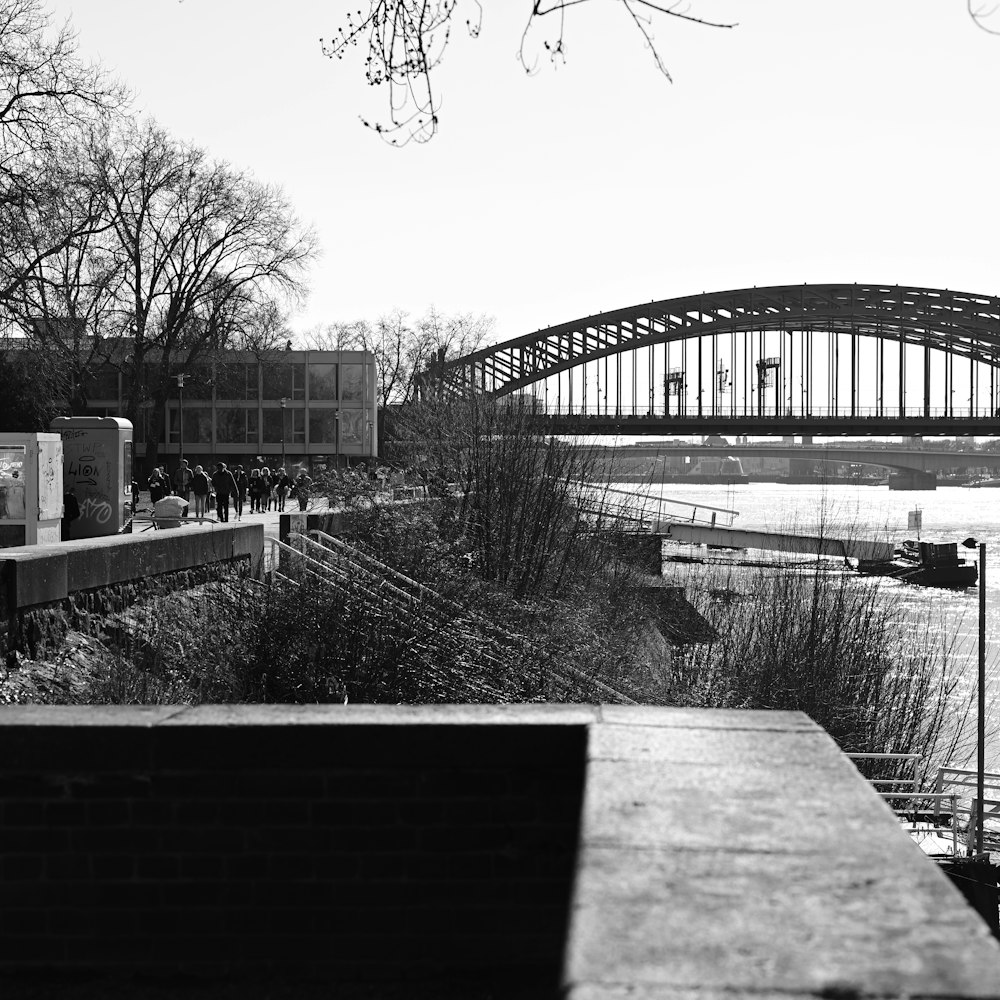 a black and white photo of a bridge over a river