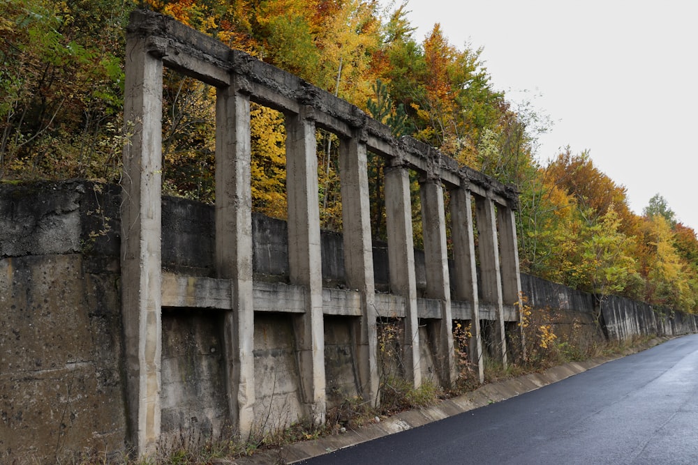 a road with a row of concrete pillars on the side of it