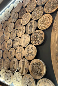 Ancestral symbols carved into wood, representing cultural spiritual connection.