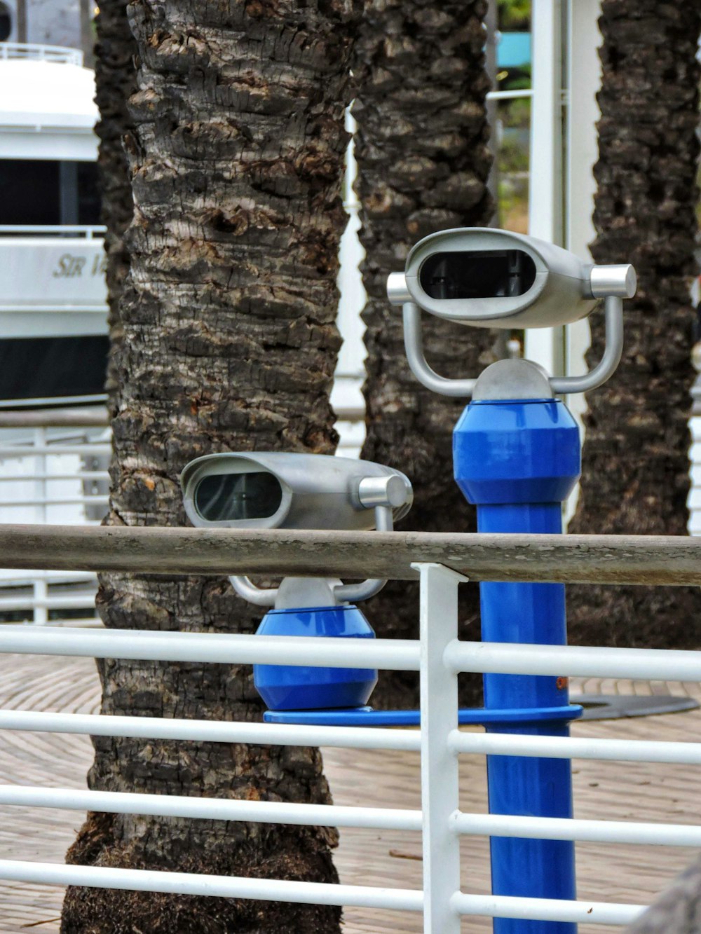a couple of blue objects sitting on top of a metal rail