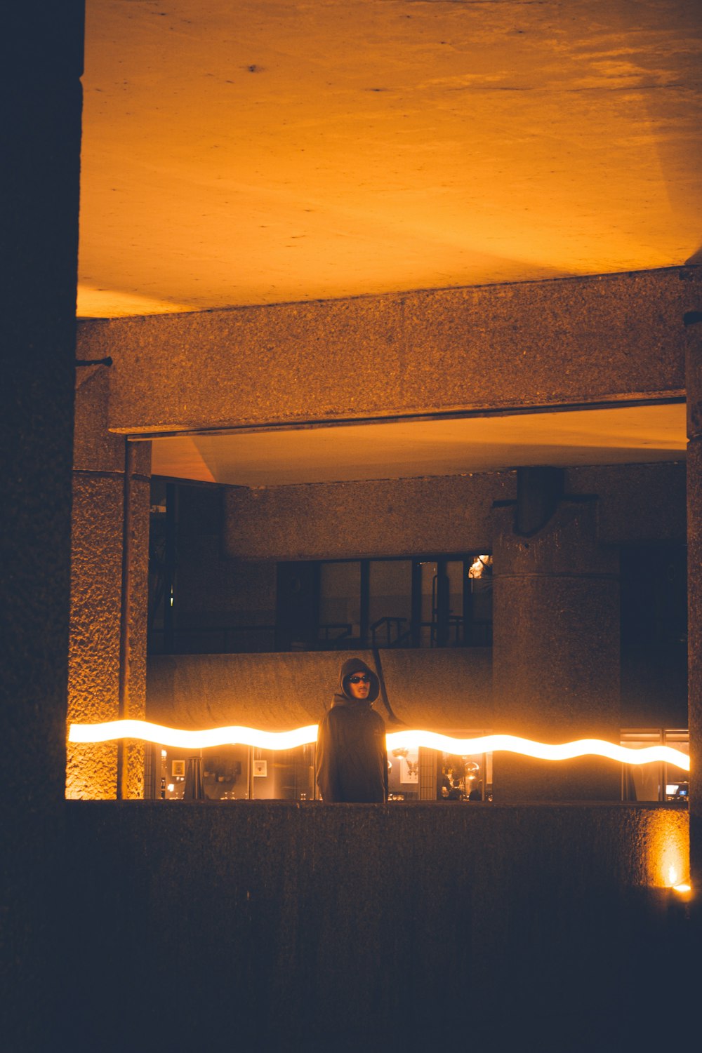 a person standing in front of a building at night