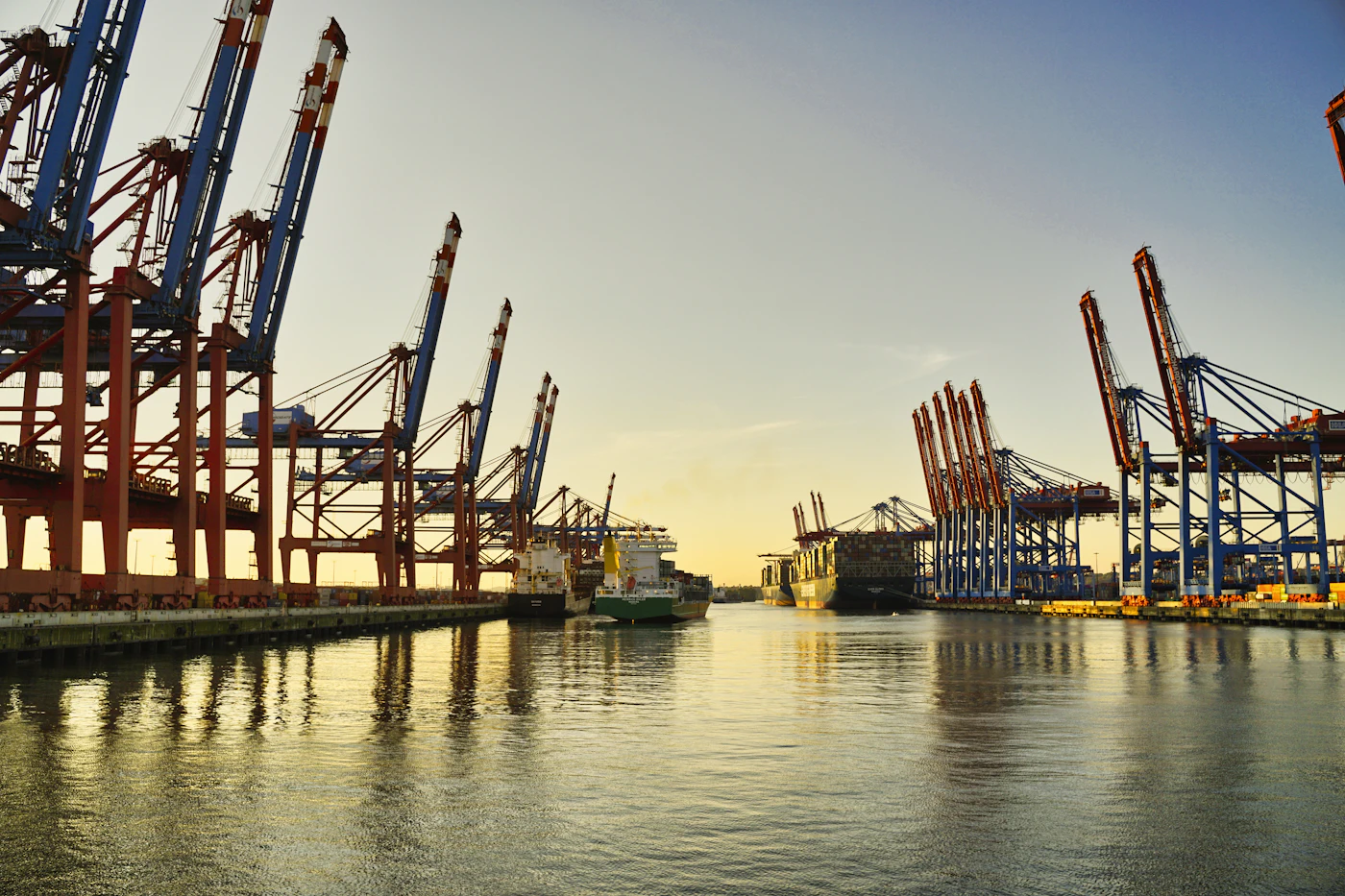 Row of harbour cranes along the waterfront at dusk