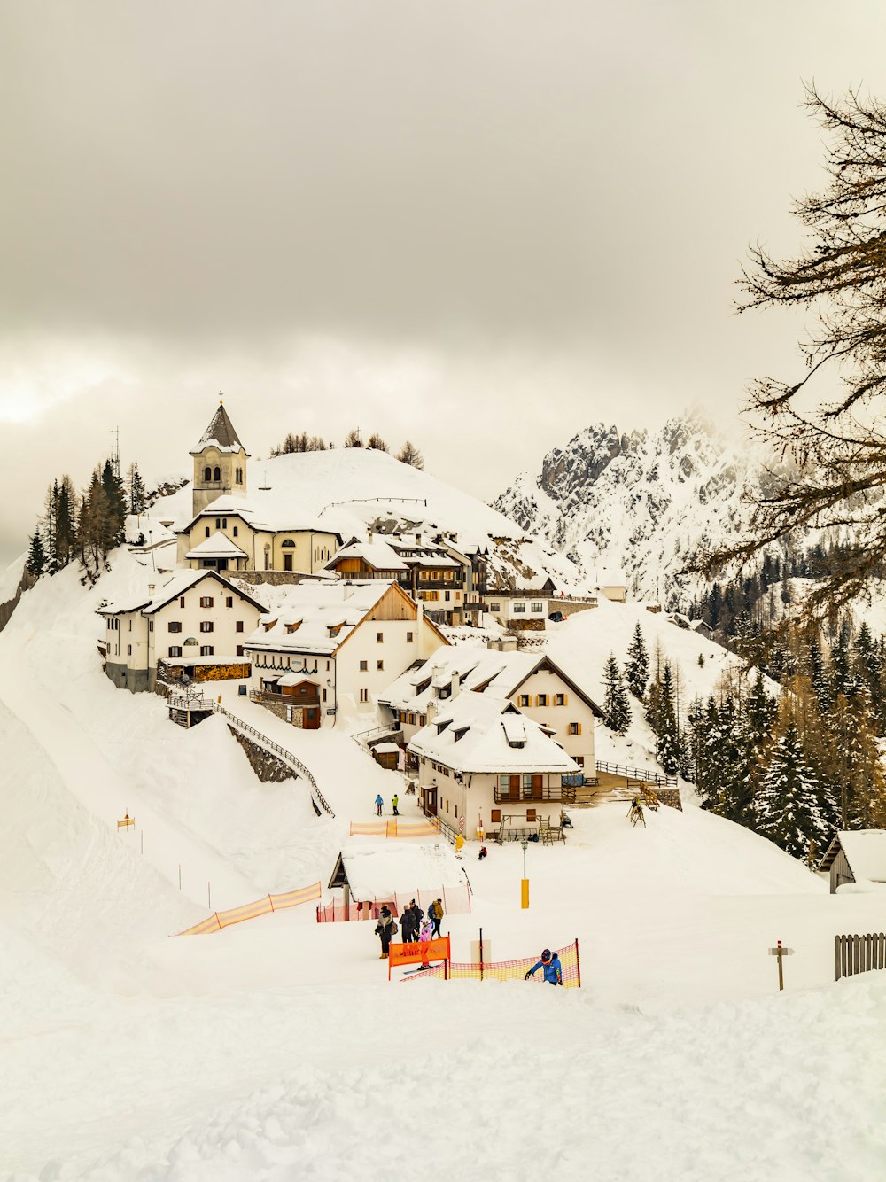 a group of people standing on top of a snow covered slope