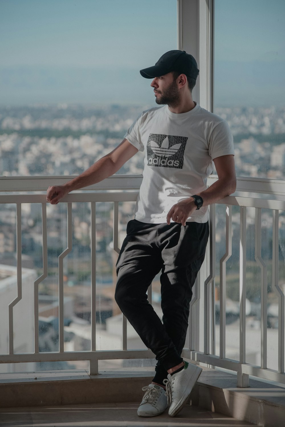 a man sitting on a ledge in front of a window