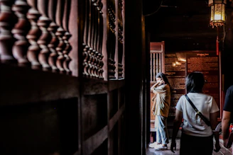 A thoughtful mentor and student sharing ideas among historical artifacts in a warmly lit study.