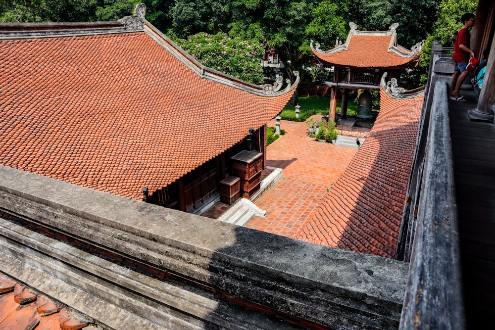 an aerial view of a building with a red roof