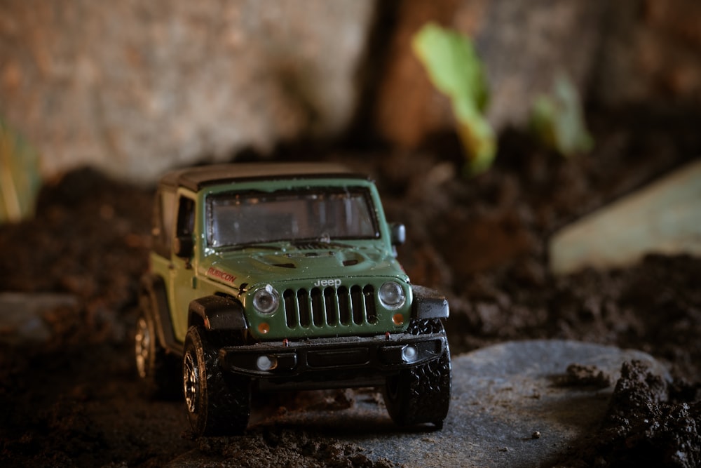 a toy jeep is sitting in the dirt